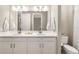 Bathroom with double vanity, white cabinets, and a toilet at 16127 Fortezza Dr, Bradenton, FL 34211