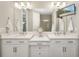Double vanity bathroom with a large mirror and modern lighting at 16127 Fortezza Dr, Bradenton, FL 34211