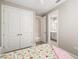 Bedroom with floral bedding, a private bathroom, and double doors to a closet at 16127 Fortezza Dr, Bradenton, FL 34211
