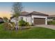 Single-story home with brown garage door, landscaping, and a paved driveway at 16127 Fortezza Dr, Bradenton, FL 34211