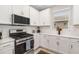 White kitchen with stainless steel appliances and white subway tile at 16127 Fortezza Dr, Bradenton, FL 34211