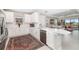 Open kitchen features white cabinets, stainless steel appliances, and views to backyard at 16127 Fortezza Dr, Bradenton, FL 34211