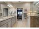 Primary bathroom with dual vanities, granite counters, and walk-in shower at 19451 Quisto St, Venice, FL 34293