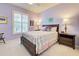 Bedroom with double bed, window with shutters and dark wood furniture at 19451 Quisto St, Venice, FL 34293