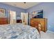 Main bedroom with large bed, dresser, and TV at 19451 Quisto St, Venice, FL 34293