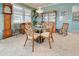 Bright dining room with glass-top table, wood chairs, and built-in hutch at 19451 Quisto St, Venice, FL 34293