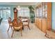 Dining area with round glass table, wood chairs, and a built-in hutch at 19451 Quisto St, Venice, FL 34293