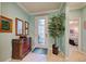 Bright entryway with decorative console table and view into the living area at 19451 Quisto St, Venice, FL 34293