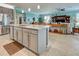 Kitchen island with granite countertop, stainless steel appliances, and view into living room at 19451 Quisto St, Venice, FL 34293