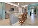 Kitchen with granite countertops, stainless steel appliances, and gray cabinets at 19451 Quisto St, Venice, FL 34293