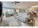Spacious living room with comfortable seating, large TV, and access to a lanai at 19451 Quisto St, Venice, FL 34293