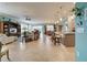 Open living space with tile floors, kitchen island, and access to the pool area at 19451 Quisto St, Venice, FL 34293