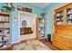 Home office with wood shelving, a comfortable chair, and hardwood floors at 19451 Quisto St, Venice, FL 34293