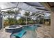 Relaxing pool and spa area with covered patio and lush landscaping at 19451 Quisto St, Venice, FL 34293