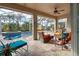 Spacious covered patio with comfortable seating overlooking the pool and spa at 19451 Quisto St, Venice, FL 34293