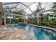 Enjoy this beautiful pool and spa with a covered patio and lush landscaping at 19451 Quisto St, Venice, FL 34293
