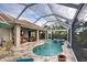 Inviting pool and spa with covered patio, outdoor seating, and scenic views at 19451 Quisto St, Venice, FL 34293