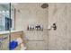 Walk-in shower with tiled walls and built-in soap holders at 19451 Quisto St, Venice, FL 34293