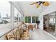 Relaxing screened porch with wicker furniture and glass-top table at 2107 Palma Sola Blvd # 59, Bradenton, FL 34209