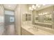 Bathroom with double vanity and modern lighting at 21628 Lake Placid Way, Venice, FL 34293