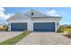 Two-car garage and front landscaping of a new home at 21628 Lake Placid Way, Venice, FL 34293