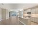 Open kitchen with an island, stainless steel appliances, and white cabinets at 21628 Lake Placid Way, Venice, FL 34293