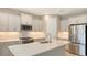Modern kitchen with white cabinets, quartz countertops, and stainless steel appliances at 21628 Lake Placid Way, Venice, FL 34293