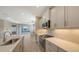 Modern kitchen with white cabinets, quartz countertops, and stainless steel appliances at 21628 Lake Placid Way, Venice, FL 34293