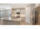 Modern kitchen with white cabinets, quartz countertops, and stainless steel appliances at 21628 Lake Placid Way, Venice, FL 34293