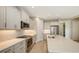 Modern kitchen with white cabinets, quartz countertops, and stainless steel appliances at 21628 Lake Placid Way, Venice, FL 34293