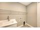 Laundry room with sink, shelving and tile floor at 21628 Lake Placid Way, Venice, FL 34293