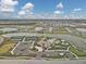 Aerial view of community with lake, tennis courts, and clubhouse at 3206 Hilltop Cir, Bradenton, FL 34211
