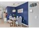 Dining area with a rustic table and blue accent wall at 3206 Hilltop Cir, Bradenton, FL 34211