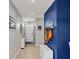 Bright entryway with blue accent wall and tiled floor at 3206 Hilltop Cir, Bradenton, FL 34211