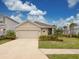 Tan house with a two-car garage and landscaped lawn at 3206 Hilltop Cir, Bradenton, FL 34211