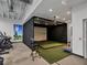 Indoor golf simulator with artificial turf and seating at 3206 Hilltop Cir, Bradenton, FL 34211