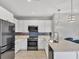 Modern kitchen with stainless steel appliances and white cabinets at 3206 Hilltop Cir, Bradenton, FL 34211