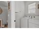 Convenient laundry room with washer, dryer, and overhead cabinet at 3206 Hilltop Cir, Bradenton, FL 34211