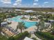 Overhead view of a large pool with plenty of lounge chairs at 3206 Hilltop Cir, Bradenton, FL 34211