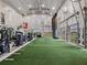 Spacious weight room with turf, strength training equipment, and large doors at 3206 Hilltop Cir, Bradenton, FL 34211