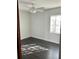 Bright bedroom with dark hardwood floors and a ceiling fan at 3301 N Avenida Republica De Cuba, Tampa, FL 33605