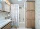 Bathroom with tub shower, linen storage and updated vanity at 3333 26Th E Ave # 1241, Bradenton, FL 34208
