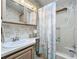 Bathroom with tub shower, vanity, and updated flooring at 3333 26Th E Ave # 1241, Bradenton, FL 34208
