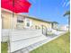 Outdoor patio with seating, umbrella, and adjacent lawn at 3333 26Th E Ave # 1241, Bradenton, FL 34208