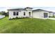 House with gray garage door and lush green lawn at 3425 Dryden St, North Port, FL 34288