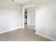 Light-filled room with tile floors and view of kitchen at 3425 Dryden St, North Port, FL 34288