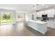 Open kitchen with island, stainless steel appliances, and white cabinets at 3425 Dryden St, North Port, FL 34288