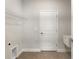 Laundry room with tile floor, shelving and space for a full-size washer and dryer at 3425 Dryden St, North Port, FL 34288