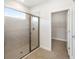 Walk-in shower with glass enclosure and tile surround at 3425 Dryden St, North Port, FL 34288
