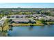 Overhead view of home with lush landscaping and a tranquil lake, perfect for outdoor enjoyment at 3663 Muirfield Dr # 4B, Sarasota, FL 34238